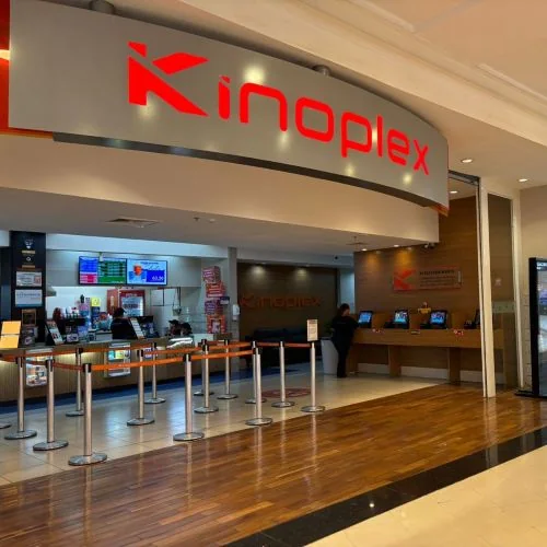 Fachada e bilheteria de uma unidade Kinoplex, com o letreiro vermelho da rede